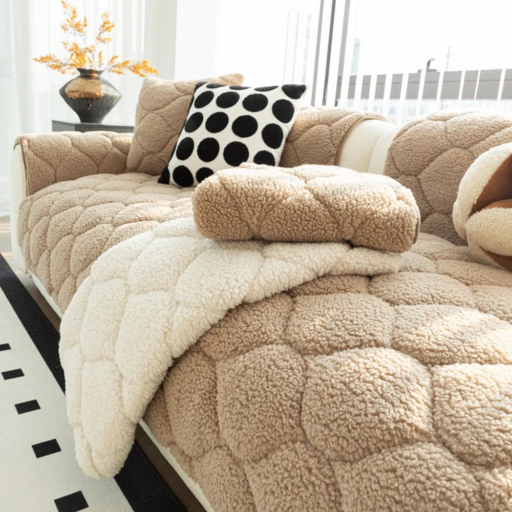 Beige quilted sherpa fleece sofa cover neatly protecting a modern couch with soft cushions and a matching throw