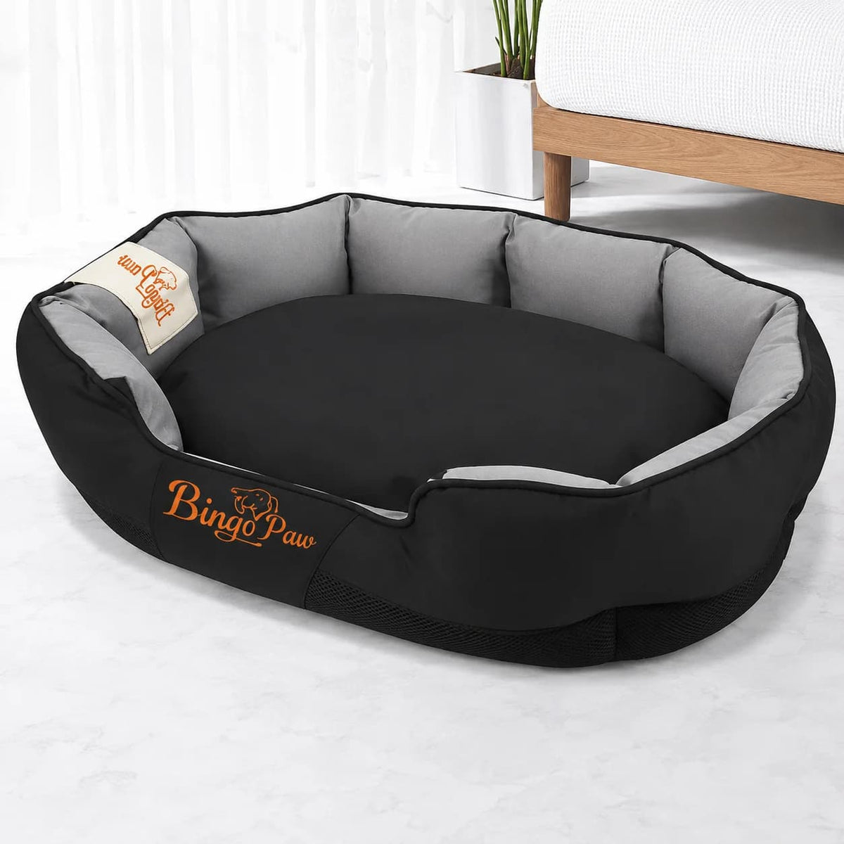 Black cushioned dog sofa bed with supportive raised sides displayed clearly on a clean background.
