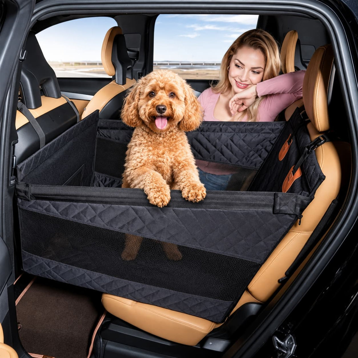Dog sitting in a black car hammock seat cover with raised sides and mesh ventilation panel