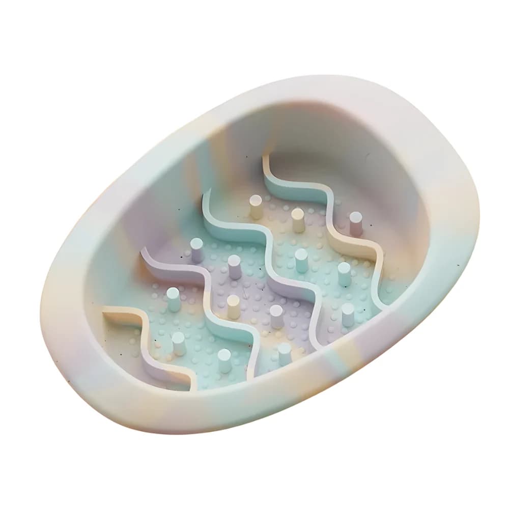 Grey and pastel oval cat slow feeder bowl with raised maze pattern on a clean white background
