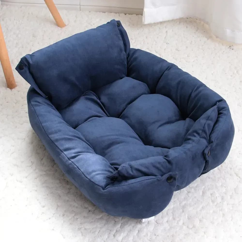 Navy blue tufted pet bed with thick cushioned bolsters and a soft padded sleeping surface.