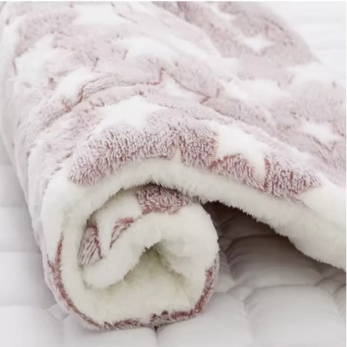 Cosy pink patterned dog blanket with thick soft white sherpa lining for added warmth