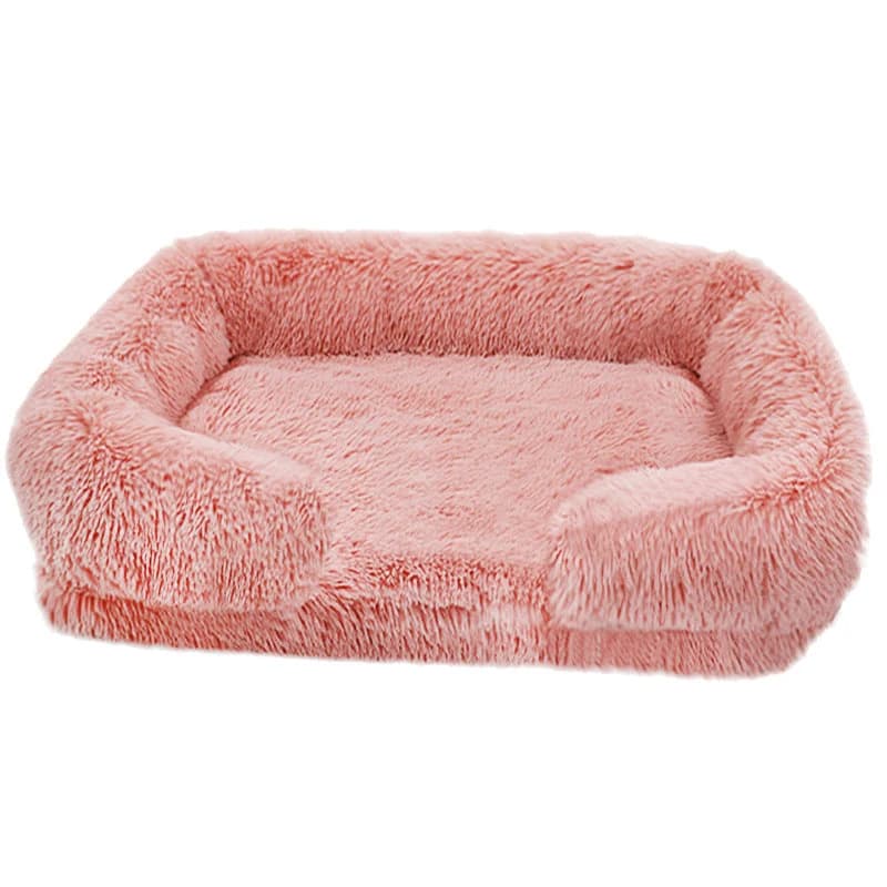 Pink rectangular plush dog bed with soft raised edges and cushioned sleeping area