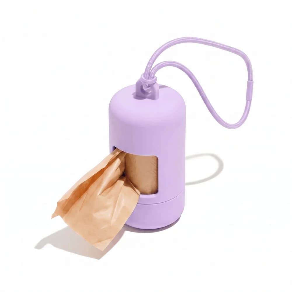 Purple dog waste bag dispenser with attached strap and waste bag ready for use.